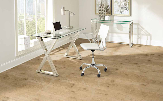 wide planked warm toned luxury vinyl plank floors in a bright minimalist office